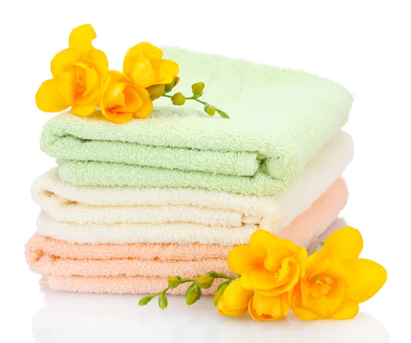 Colorful towels and flowers isolated on white — Stock Photo, Image