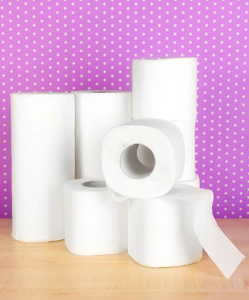 Rolls of toilet paper on purple with dots background — Stockfoto