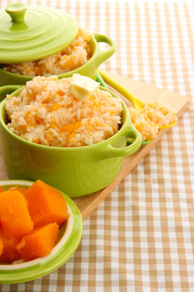 Pruebe la papilla de arroz con calabaza en cacerolas sobre fondo de mantel — Foto de Stock