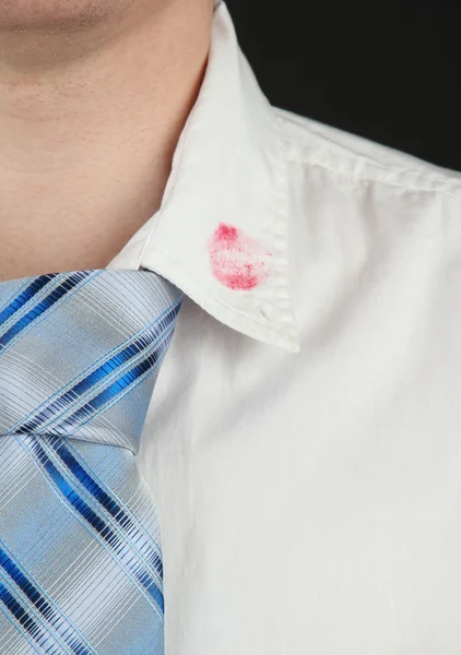 Κραγιόν φιλί στο γιακά πουκάμισο του ανθρώπου, που απομονώνονται σε μαύρο — Φωτογραφία Αρχείου