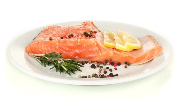 Fresh salmon fillet with herbals and lemon slices on plate, isolated on white — Stock Photo, Image