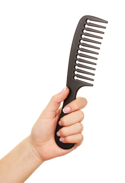 Black comb in female hand isolated on white — Stock Photo, Image