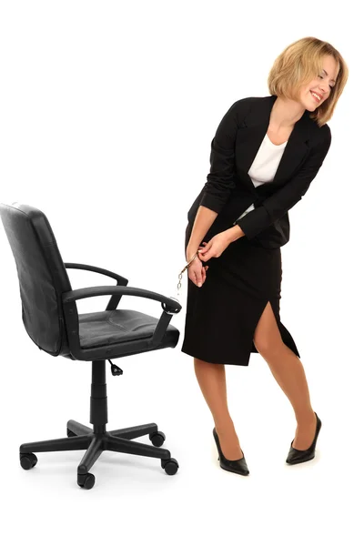 Young beautiful business woman strapped to chair with handcuffs isolated on white — Stock Photo, Image