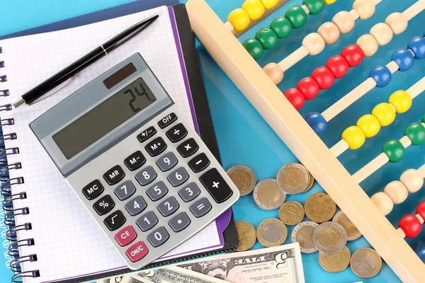 Bright wooden abacus and calculator. Conceptual photo of old and modern business — Stock Photo, Image