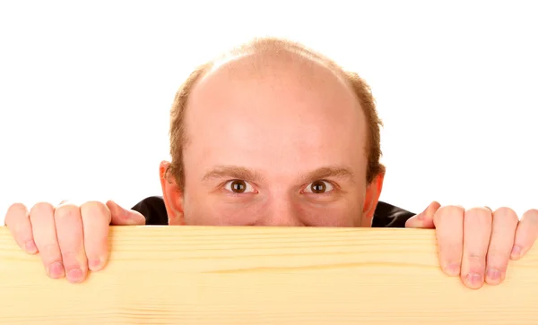 Man peeking from wooden desk, isolated on white — Stock Photo, Image