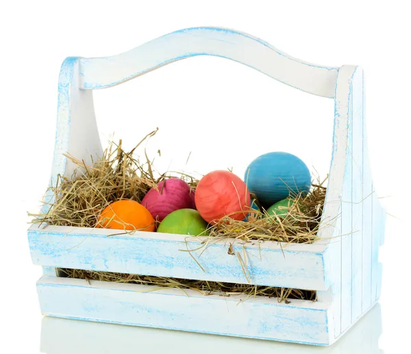 Easter eggs in wooden basket isolated on white — Stock Photo, Image