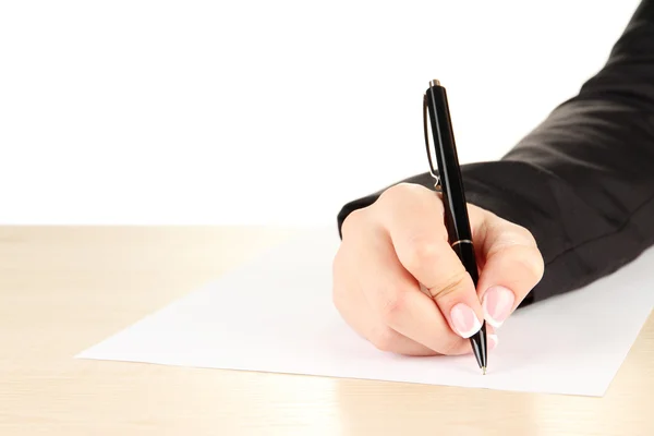 Hand with pen on white paper, on wooden table on white background Stock Picture