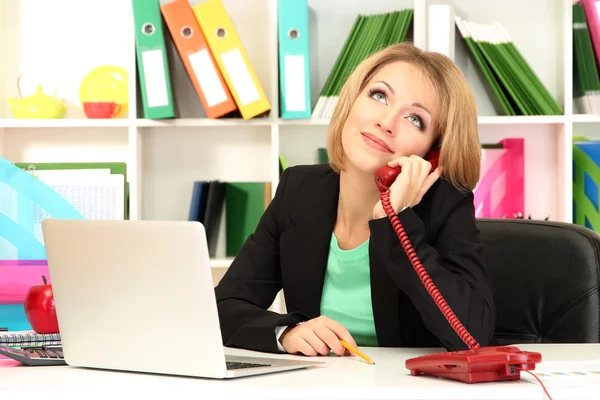 Beautiful young business woman working in office Stock Photo
