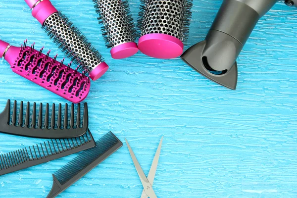 Comb brushes, hairdryer and cutting shears,on color background — Stock Photo, Image