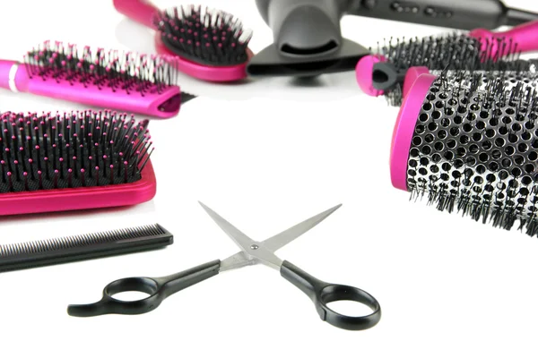 Comb brushes, hairdryer and cutting shears, isolated on white — Stock Photo, Image