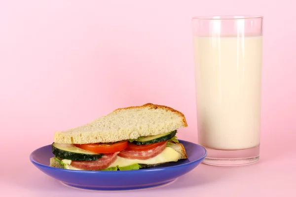 Sandwich on plate with milk on pink background — Stock Photo, Image