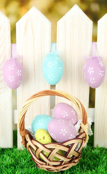 Art Easter background with eggs hanging on fence — Stock Photo, Image