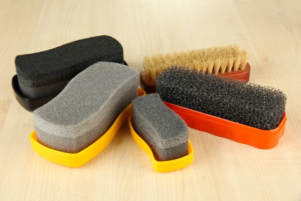 Set of stuff for cleaning and polish shoes, on wooden background — Stock Photo, Image