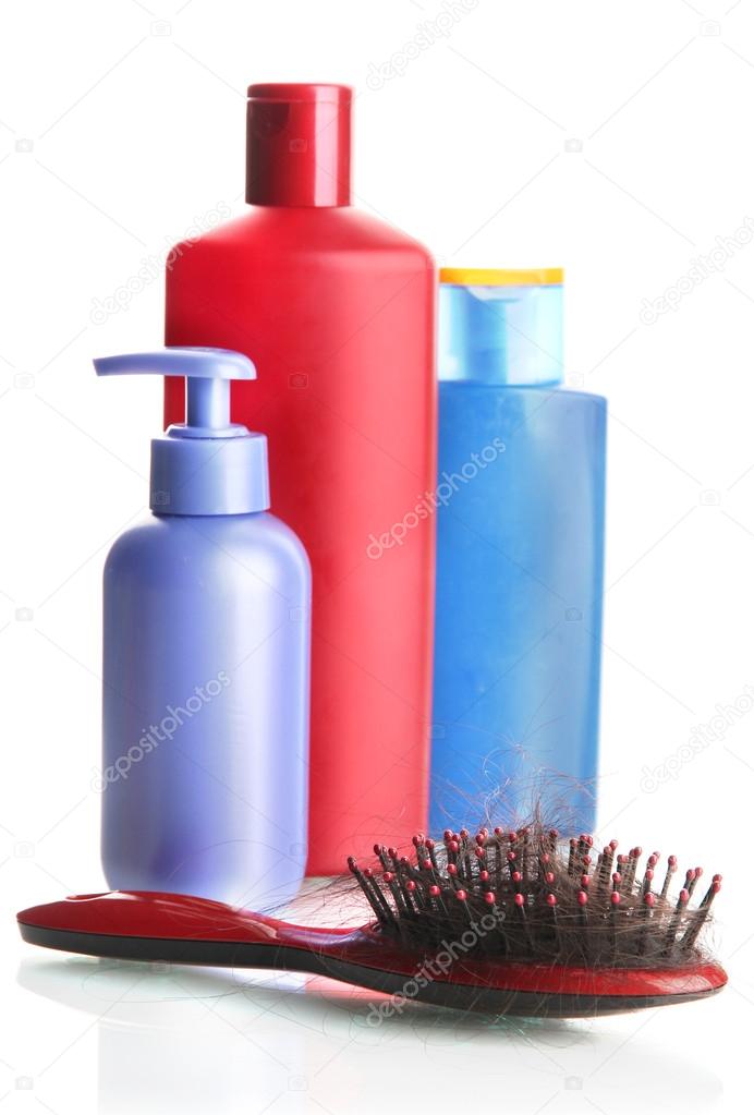 comb brush with lost hair and cosmetics bottles, isolated on white