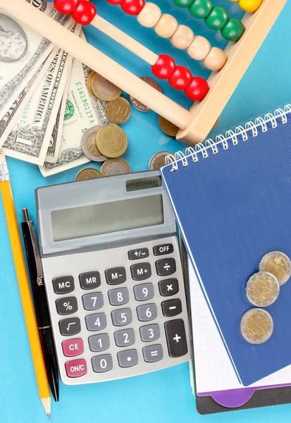 Bright wooden abacus and calculator. Conceptual photo of old and modern business — Stock Photo, Image