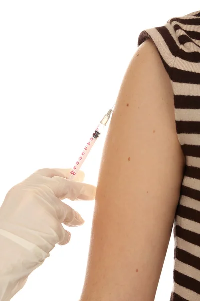 Doctor holding syringe with a vaccine in the patient shoulder, isolated on white — Stock Photo, Image