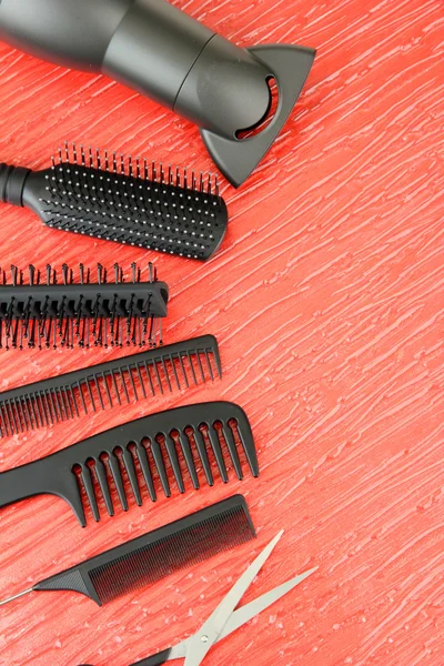 Comb brushes, hairdryer and cutting shears,on color background — Stock Photo, Image