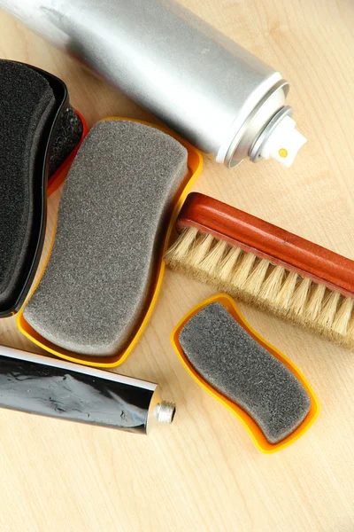 Set of stuff for cleaning and polish shoes, on wooden background — Stock Photo, Image