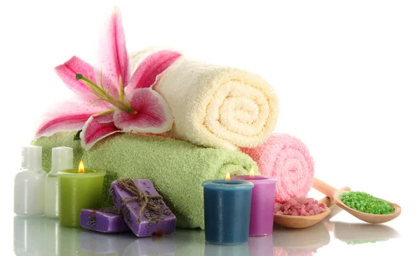 Towels with lily, aroma oil, candles, soap and sea salt isolated on white — Stock Photo, Image