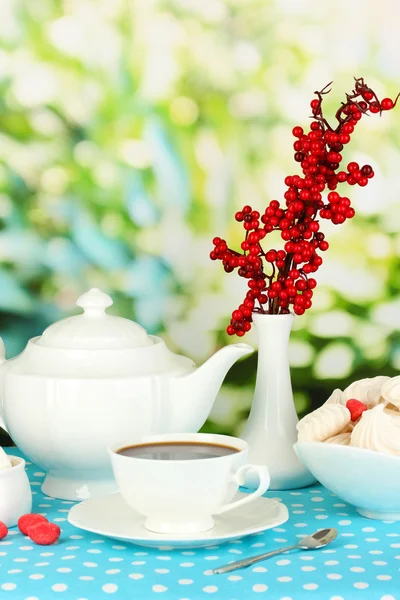 Schönes weißes Abendessen mit Luftmeringues auf blauer Tischdecke auf natürlichem Hintergrund — Stockfoto