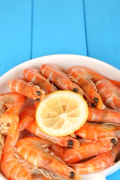 Krevety s citronem na štítku na dřevěný stůl detail — Stock fotografie