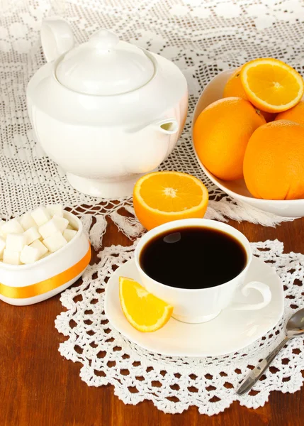 Beautiful white dinner service with oranges on wooden table close-up — Stock Photo, Image