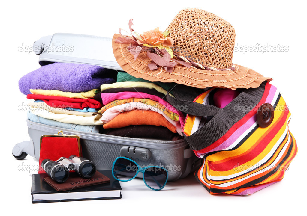 Closed silver suitcase with clothing isolated on white