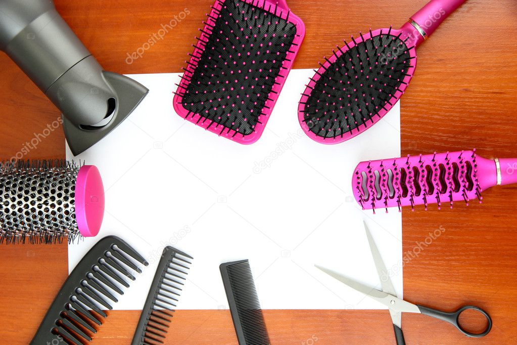 Comb brushes, hairdryer and cutting shears,on wooden background