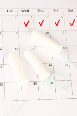 menstruation calendar with cotton tampons, close-up clipart