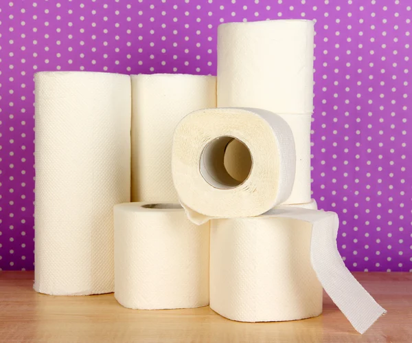 Rolls of toilet paper on purple with dots background — Stok fotoğraf