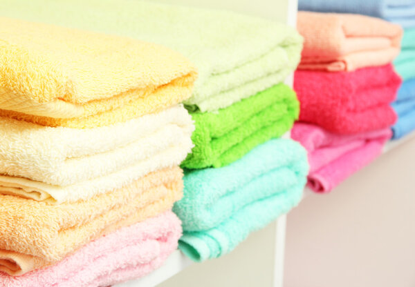colorful towels on shelves in bathroom