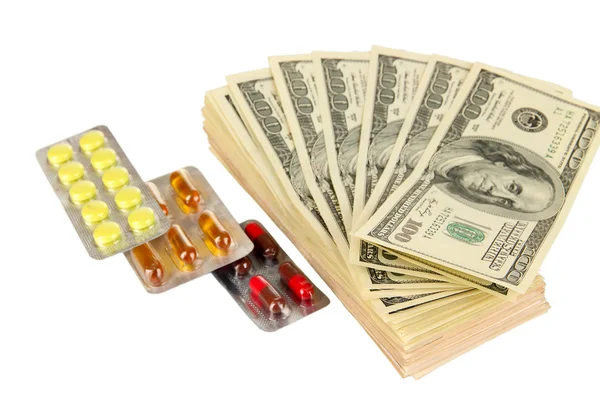 Pillen en geld geïsoleerd op wit — Stockfoto
