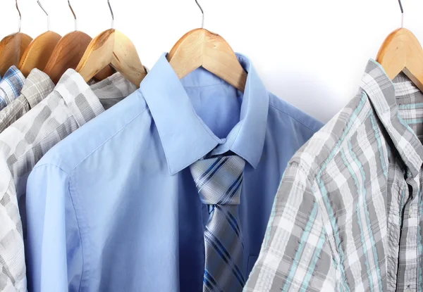 Shirts with ties on wooden hangers isolated on white — Stock Photo, Image