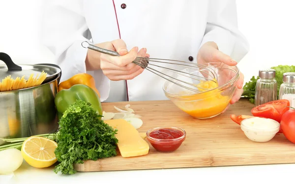 Female hands blending eggs in glass bowl — Stock Photo, Image