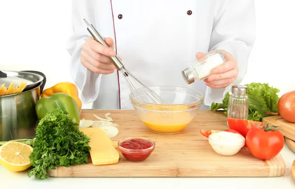 Female hands blending eggs in glass bowl — Stock Photo, Image