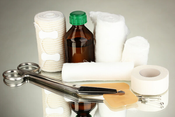 First aid kit for bandaging on grey background