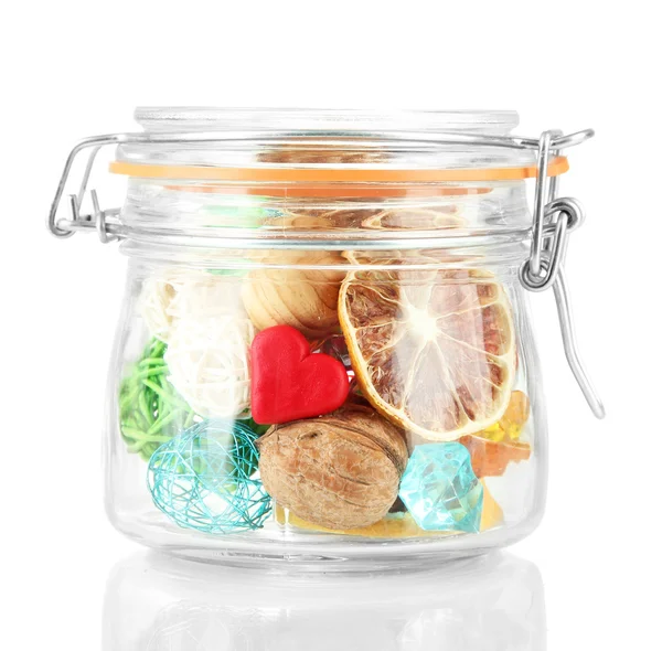 Dried oranges, wicker balls and other home decorations in glass jar, isolated on white — Stock Photo, Image