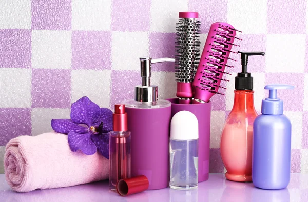 Hair brushes and cosmetic bottles in bathroom — Stock Photo, Image