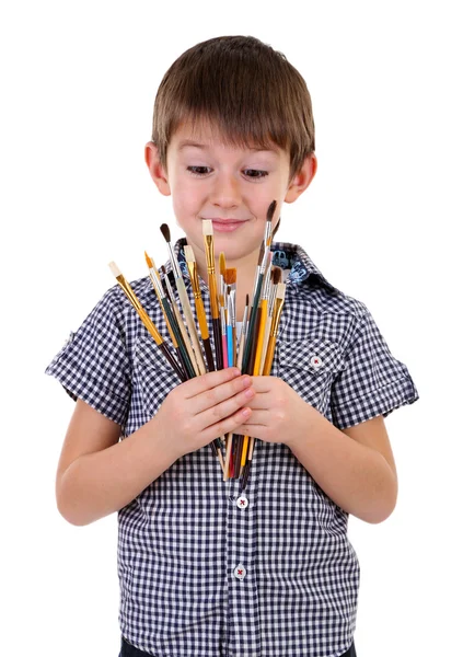 Söt liten pojke med penslar isolerad på vit — Stockfoto