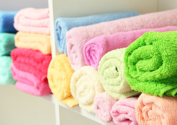 colorful towels on shelves in bathroom