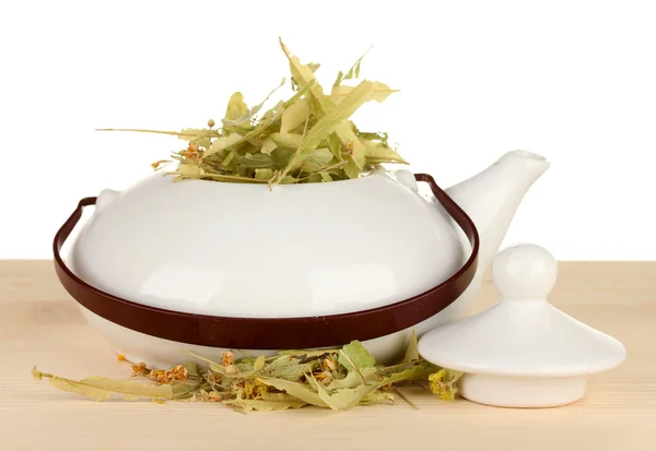 Dried herbs in teapot on wooden table, isolated on white. Conceptual photo of herbal tea. — Stock Photo, Image