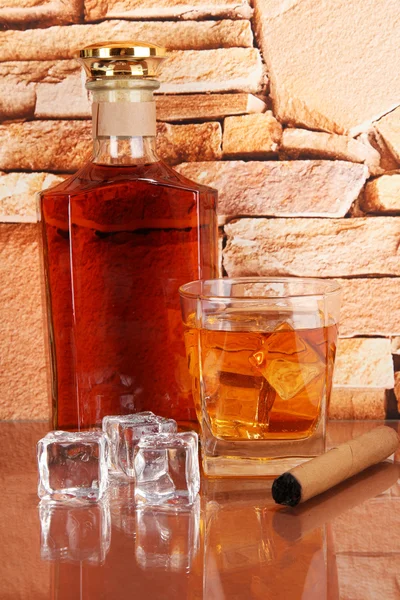 Bottle and Glass of whiskey and cigar on brick wall background — Stock Photo, Image