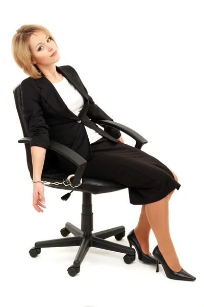 Young beautiful business woman strapped to chair with handcuffs isolated on white — Stock Photo, Image