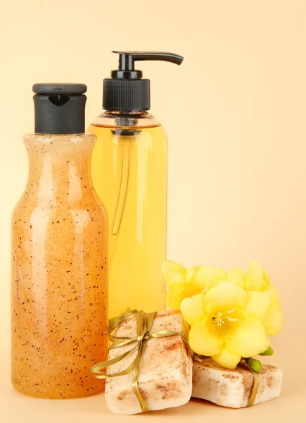 Liquid and hand-made soaps on beige background — Stock Photo, Image