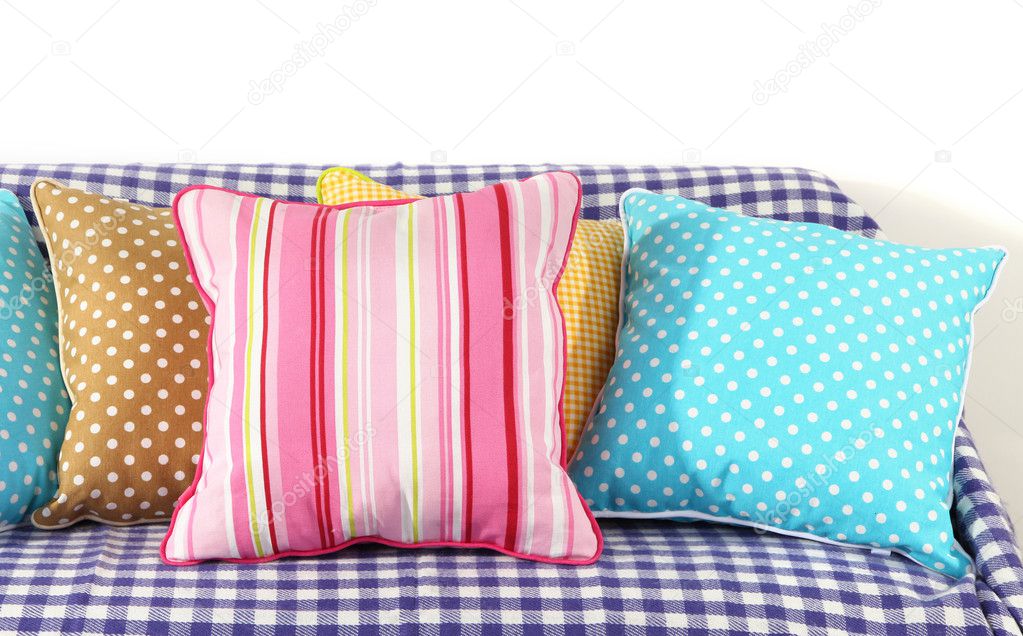 Colorful pillows on couch isolated on white