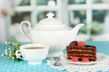 çaydanlık, fincan çay ve lezzetli pasta penceresi arka plan üzerinde
