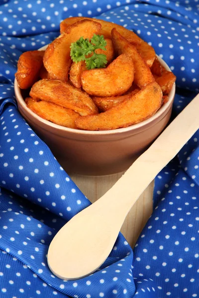 Appetizing village potatoes in bowl on blue fabric close-up — Stock Photo, Image