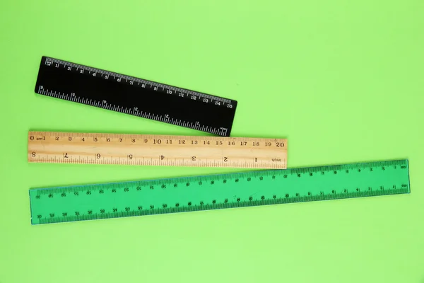 Rulers on green background — Stock Photo, Image