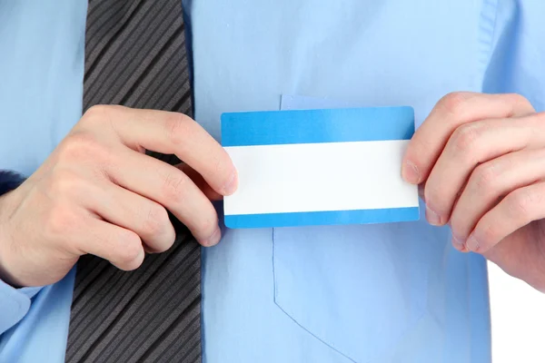 Businessman wearing blue shirt with tie and holding blank nametag close up — Stock Photo, Image