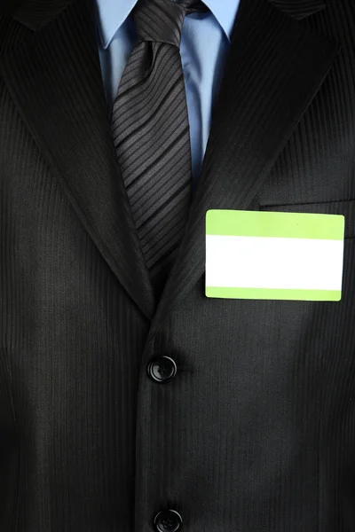 Blank nametag on businessman's black suit close up — Stock Photo, Image